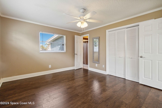 unfurnished bedroom featuring dark hardwood / wood-style flooring, ornamental molding, a textured ceiling, and ceiling fan