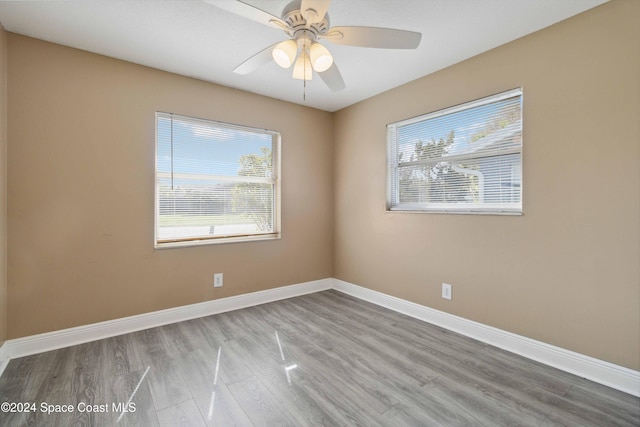 spare room featuring light hardwood / wood-style floors and ceiling fan