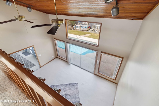 unfurnished living room featuring high vaulted ceiling, wood ceiling, and ceiling fan