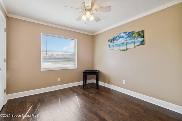 spare room with dark wood-type flooring, ceiling fan, and ornamental molding