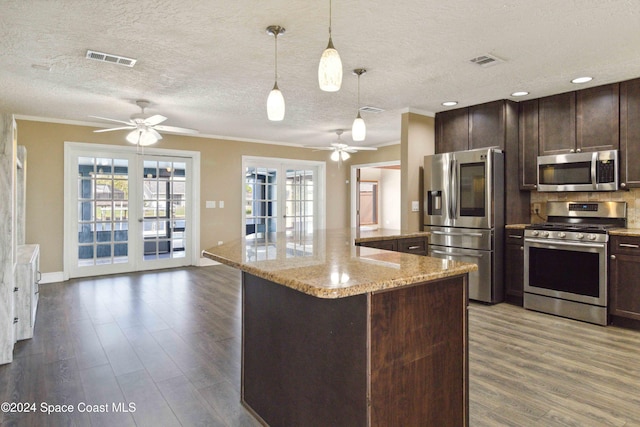 kitchen featuring stainless steel appliances, dark hardwood / wood-style floors, and plenty of natural light