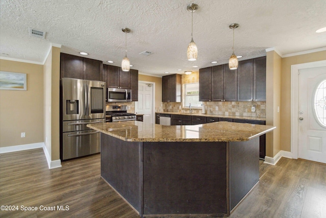 kitchen featuring stainless steel appliances, dark hardwood / wood-style flooring, dark brown cabinetry, a textured ceiling, and pendant lighting