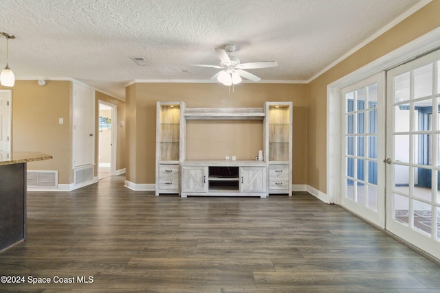 unfurnished living room featuring dark hardwood / wood-style flooring, a wealth of natural light, and ornamental molding