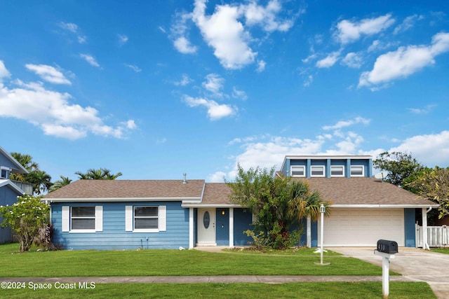 view of front of home featuring a garage and a front lawn