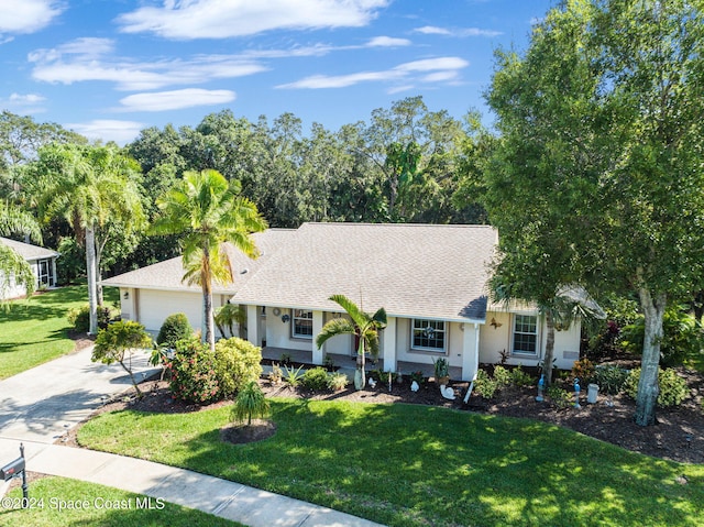 single story home featuring a front yard and a garage