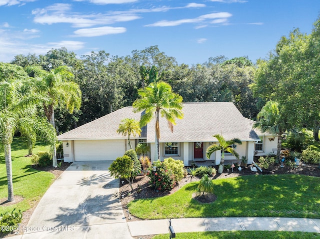 ranch-style house featuring a front yard, a porch, and a garage