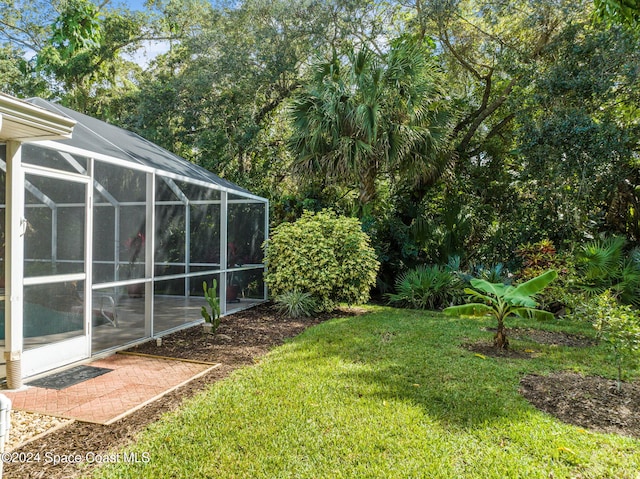 view of yard featuring glass enclosure