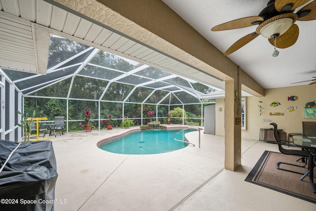 view of swimming pool featuring ceiling fan, glass enclosure, and a patio area