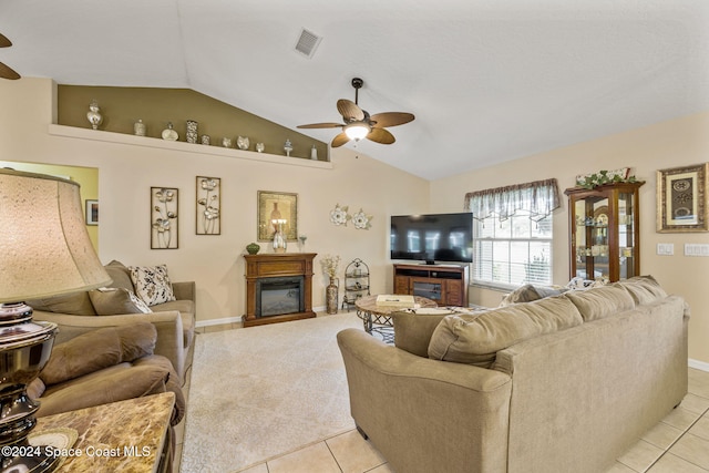 tiled living room featuring ceiling fan and lofted ceiling