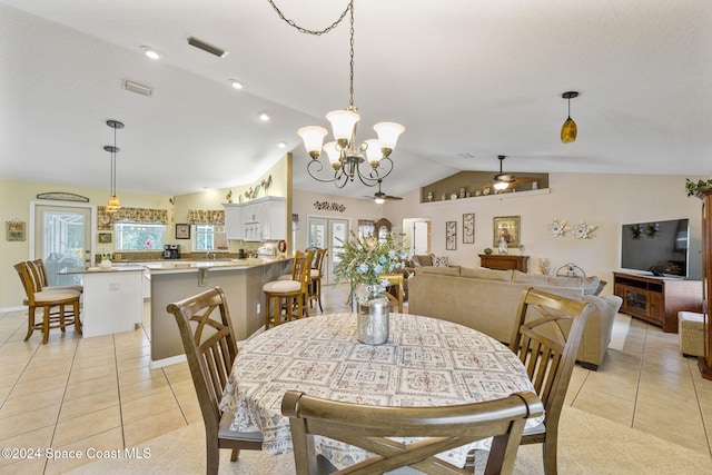 tiled dining room featuring ceiling fan with notable chandelier and vaulted ceiling