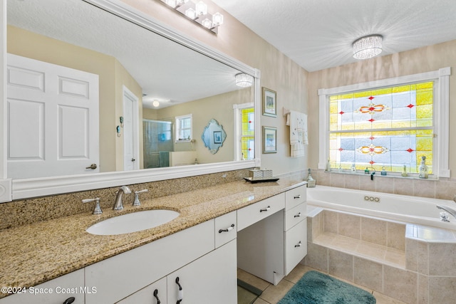 bathroom with shower with separate bathtub, a textured ceiling, tile patterned floors, and vanity