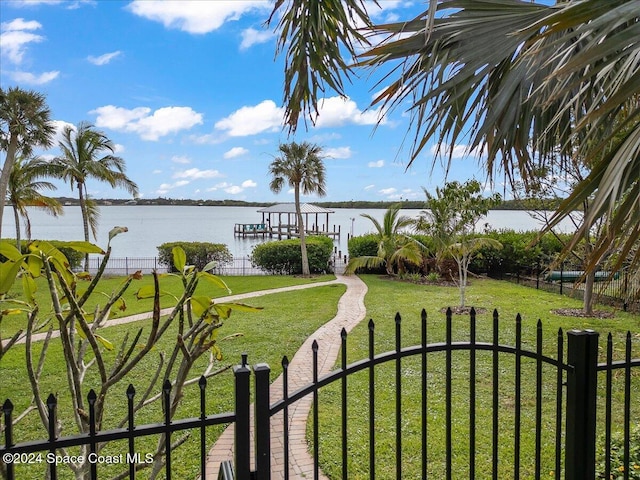 view of yard with a boat dock and a water view