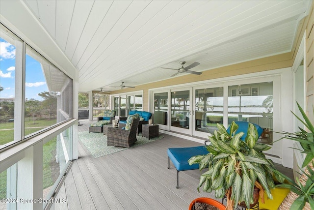 sunroom featuring a wealth of natural light, ceiling fan, and wooden ceiling