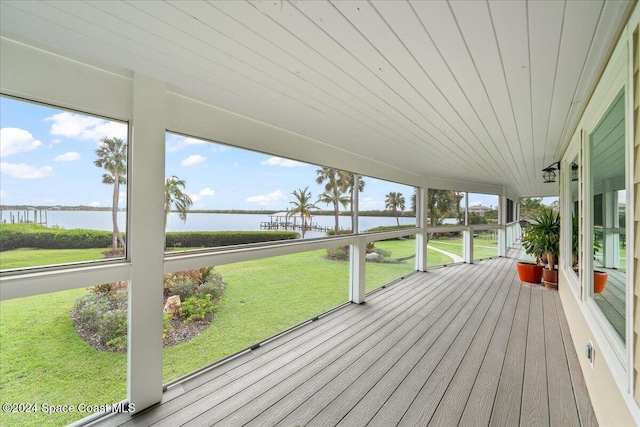 unfurnished sunroom featuring a water view and wood ceiling