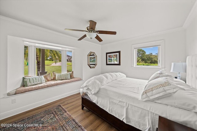 bedroom with dark hardwood / wood-style flooring, ceiling fan, and crown molding