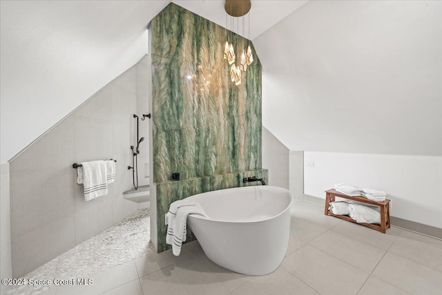 bathroom featuring tile patterned flooring, vaulted ceiling, tile walls, and plus walk in shower