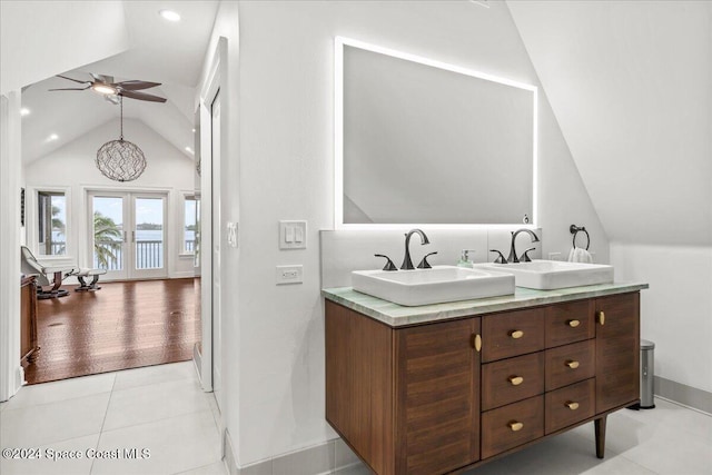 bathroom featuring hardwood / wood-style flooring, vaulted ceiling, vanity, french doors, and ceiling fan