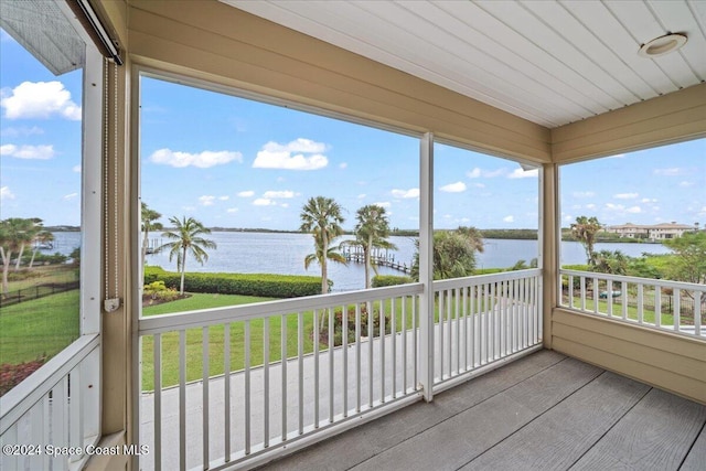 sunroom / solarium with a water view and a wealth of natural light