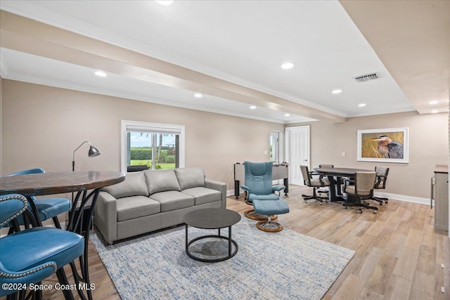 living room with light hardwood / wood-style floors and crown molding