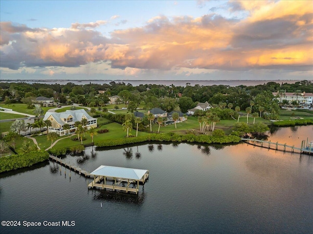 aerial view at dusk with a water view