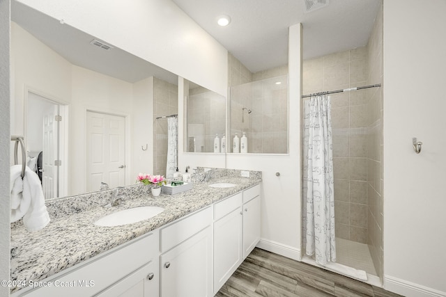 bathroom with vanity, hardwood / wood-style flooring, and a shower with curtain