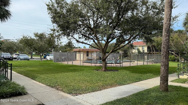 view of yard with a fenced in pool