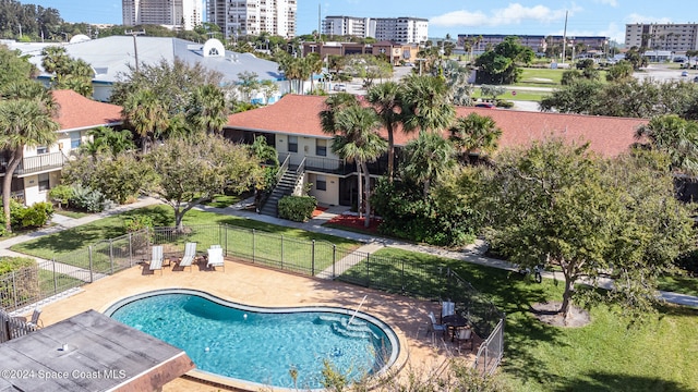 view of swimming pool with a lawn and a patio