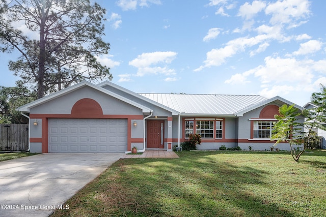 ranch-style house featuring a garage and a front yard