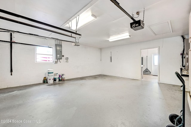 garage featuring electric panel and a garage door opener