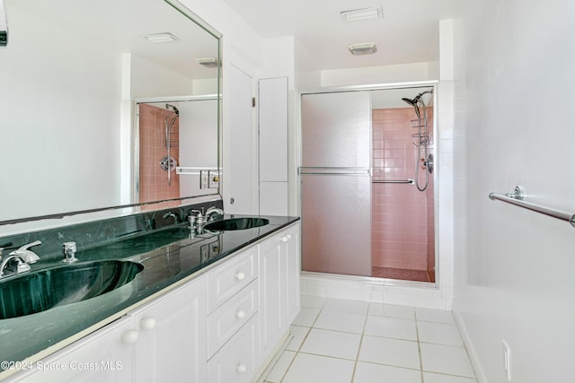 bathroom with a sink, a stall shower, and tile patterned flooring