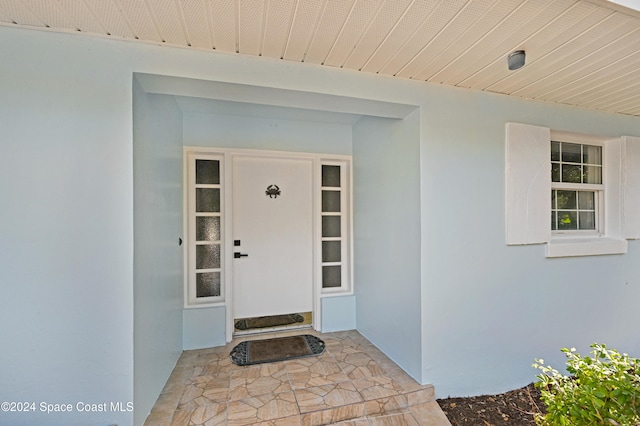 doorway to property with stucco siding