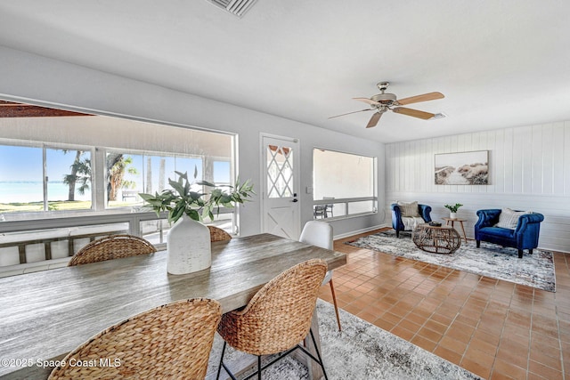 tiled dining space with a wealth of natural light, visible vents, and ceiling fan