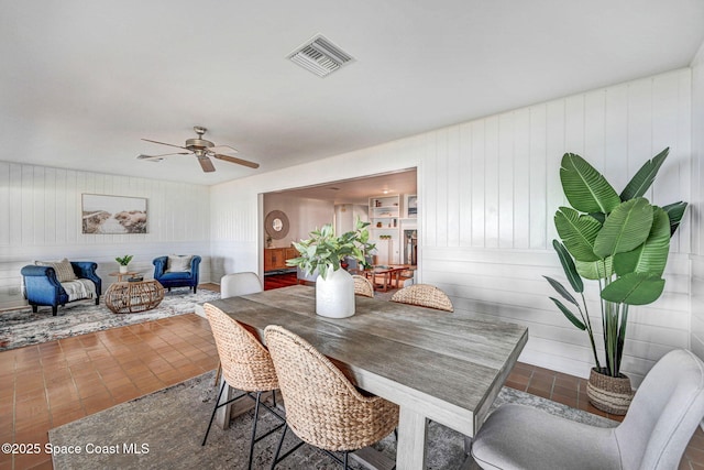 dining area featuring tile patterned floors, visible vents, and a ceiling fan