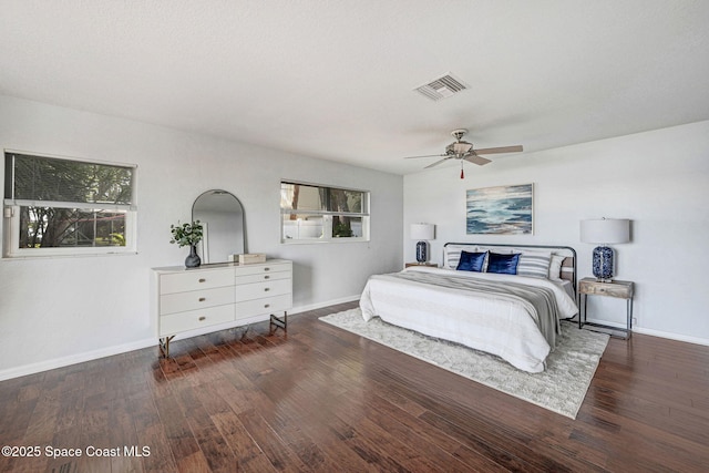 bedroom with visible vents, ceiling fan, baseboards, and wood finished floors