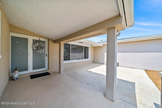 property entrance featuring a patio