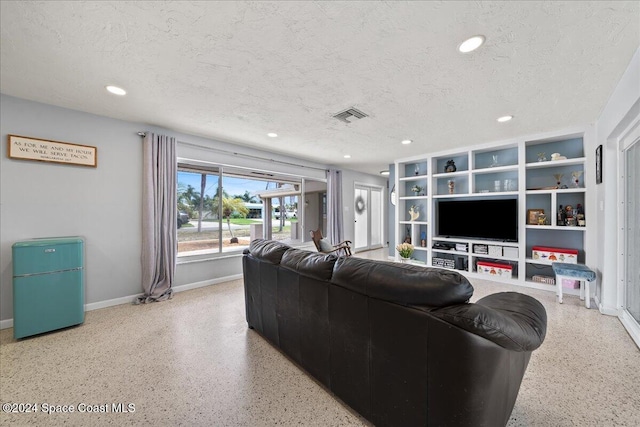 living room with a textured ceiling