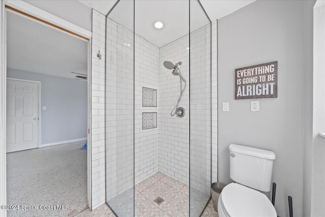 bathroom with toilet and a shower with door