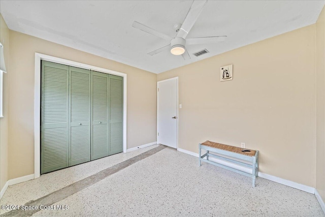 bedroom with ceiling fan and a closet