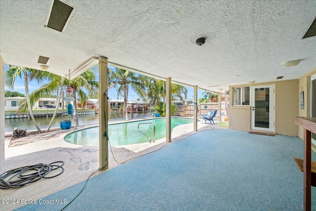 view of swimming pool featuring a patio area and a water view