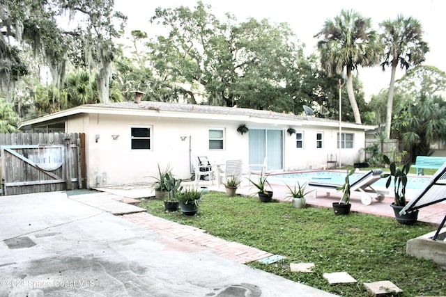 139 W Laila Dr W, Melbourne, FL 32904 - view of front facade with a patio, a gate, and stucco siding