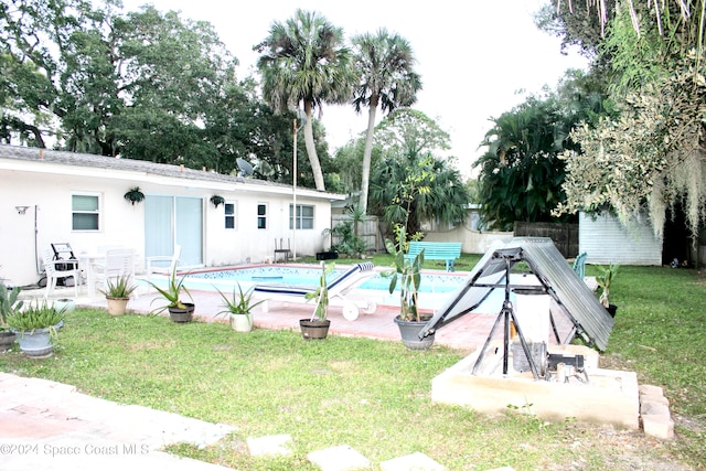 view of pool featuring a yard and a patio area