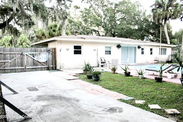 139 W Laila Dr W, Melbourne, FL 32904 - back of property featuring a gate, stucco siding, and a patio area