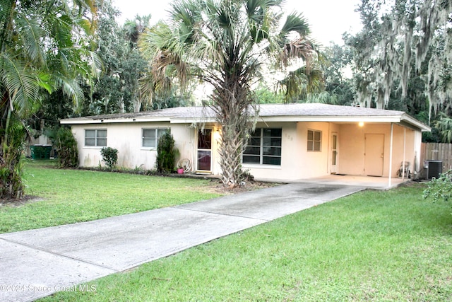 single story home with a carport, a front lawn, and cooling unit