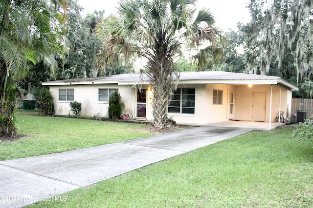 139 W Laila Dr W, Melbourne, FL 32904 - single story home with concrete driveway, stucco siding, a front yard, and central AC unit