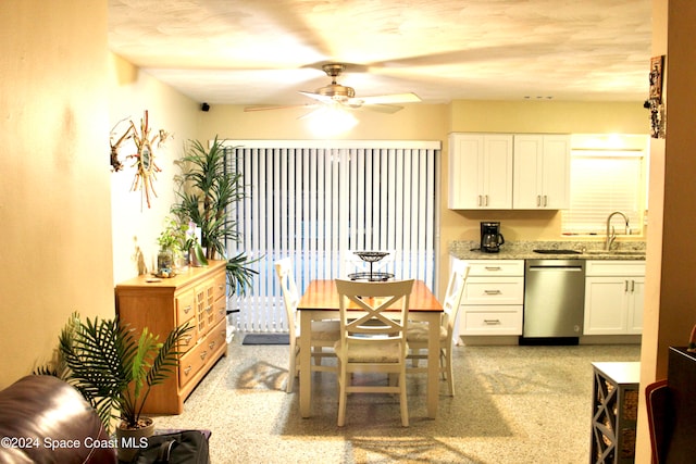 kitchen featuring white cabinetry, sink, light stone countertops, ceiling fan, and stainless steel dishwasher