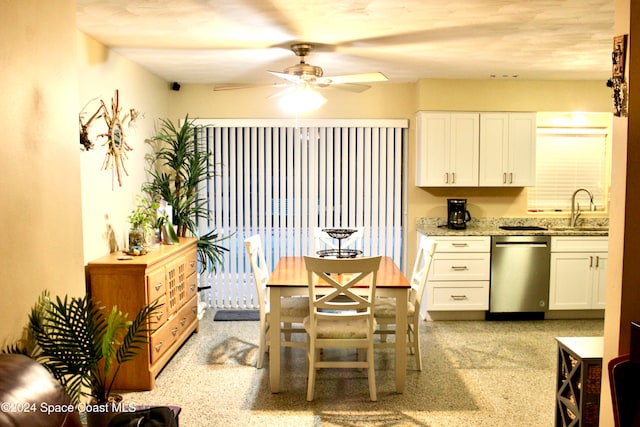 dining room featuring ceiling fan and sink