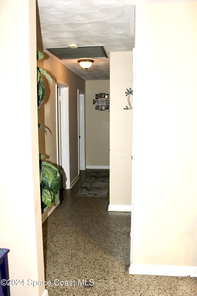 139 W Laila Dr W, Melbourne, FL 32904 - hallway featuring speckle patterned floor and baseboards