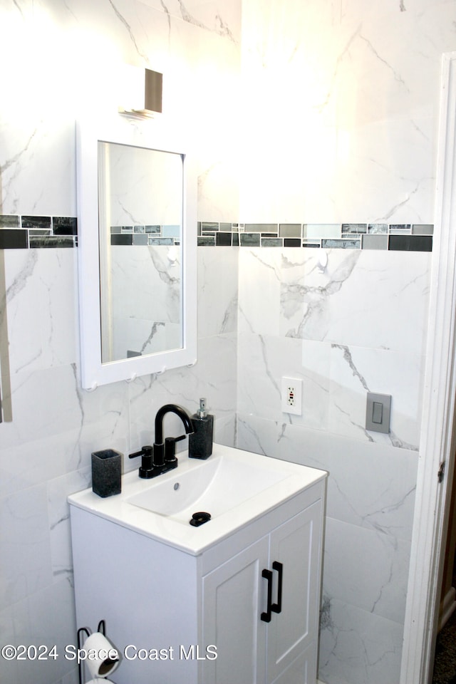 bathroom featuring tile walls, vanity, and tasteful backsplash