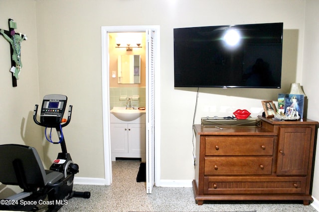 bedroom featuring ensuite bathroom and sink