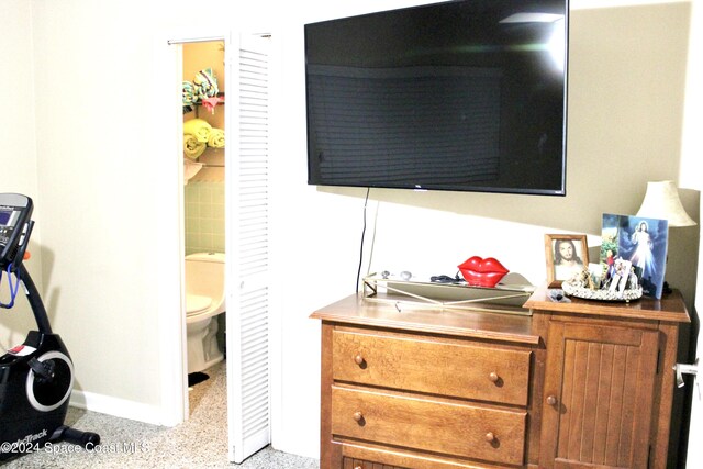 139 W Laila Dr W, Melbourne, FL 32904 - bedroom with baseboards, dark speckled floor, and ensuite bathroom